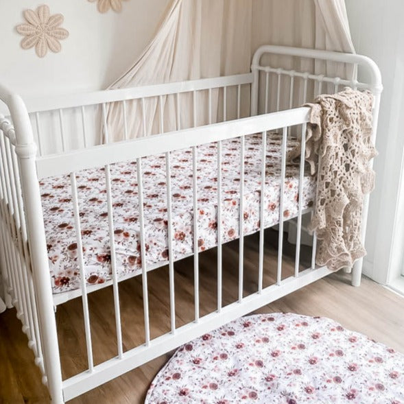 White cot placed against the nursery wall demonstarting the Willow Play Mat and Willow fitted crib sheet.