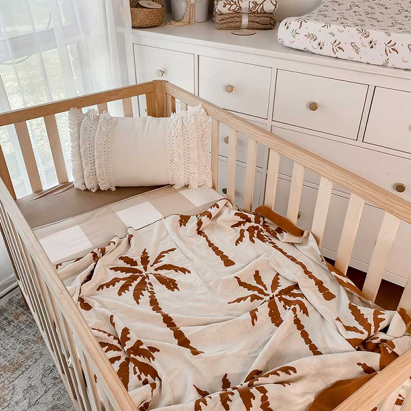 Baby Nursery with wooden crib and an Snuggly Jacks Havana Reversible Organic Knitted Blanket on the crib mattress